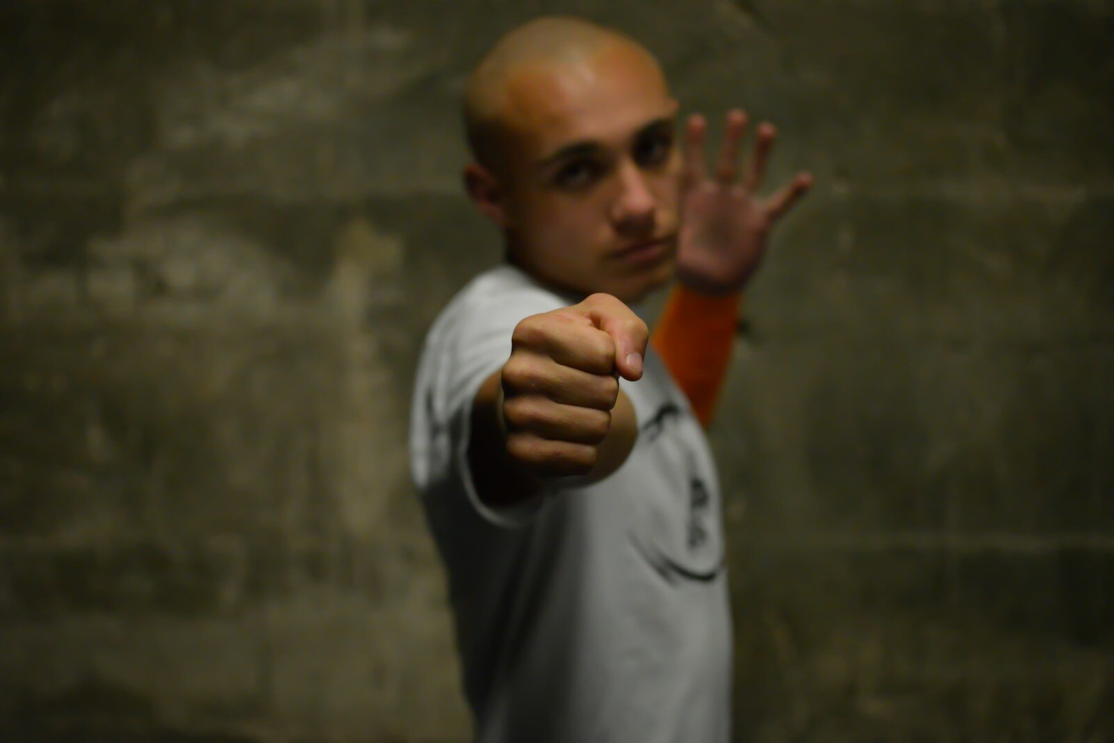 A man with a bald head pointing his finger at the camera
