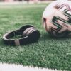 a soccer ball sitting on top of a lush green field