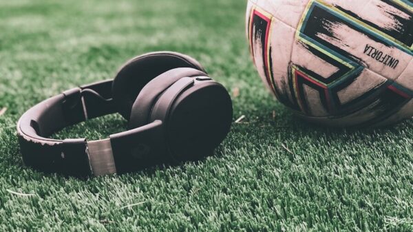 a soccer ball sitting on top of a lush green field