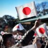 A crowd of people holding up flags in the air