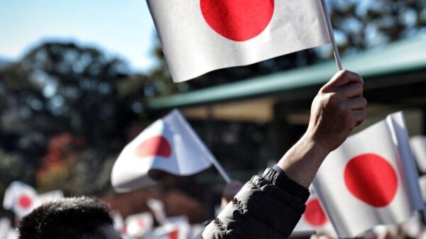 A crowd of people holding up flags in the air
