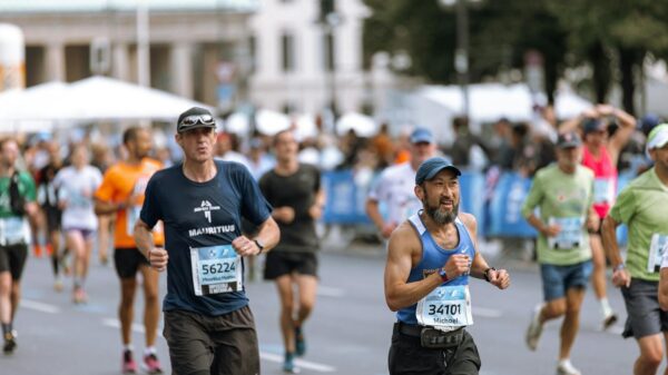 Focused runners competing in a vibrant city marathon event, showcasing athletic determination.