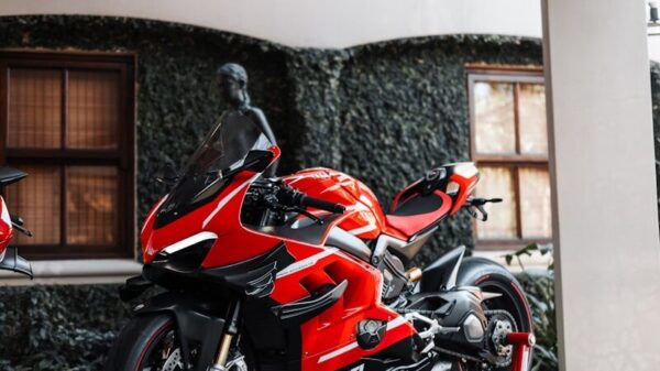 a red motorcycle parked in front of a building