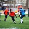 group of men playing soccer during daytime