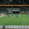 Exciting soccer match captured during day at a modern stadium.