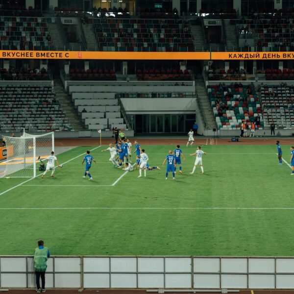 Exciting soccer match captured during day at a modern stadium.