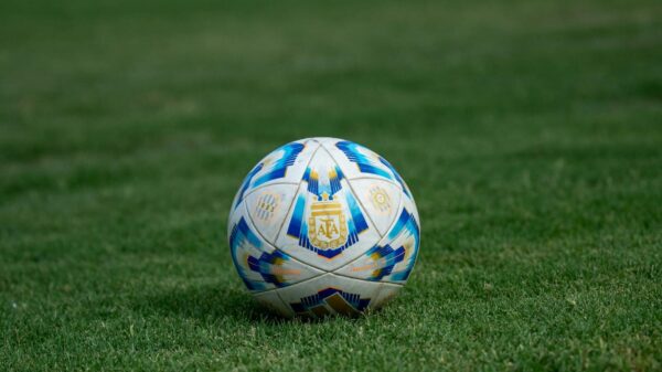Close-up of a soccer ball on a grassy field, perfect for sports-themed designs.