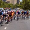 Competitive cyclists race in Adelaide, showcasing intense action and team spirit under the summer sun.