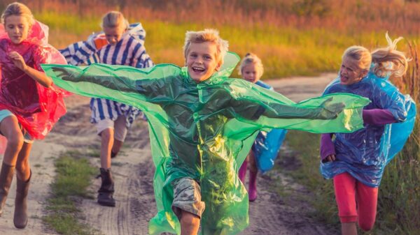 boy in green and blue jacket