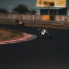 man riding motorcycle on track field during daytime
