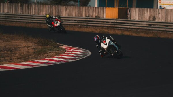 man riding motorcycle on track field during daytime