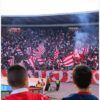 a crowd of people watching a soccer game