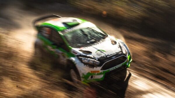white and green racing car on dirt road