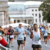 Runners cross finish line at Berlin Marathon, showcasing athletic determination.