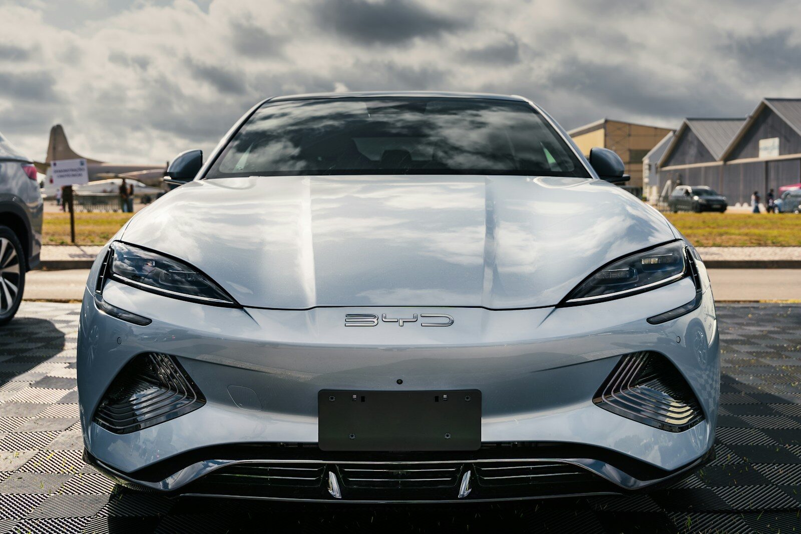 A silver sports car parked in a parking lot