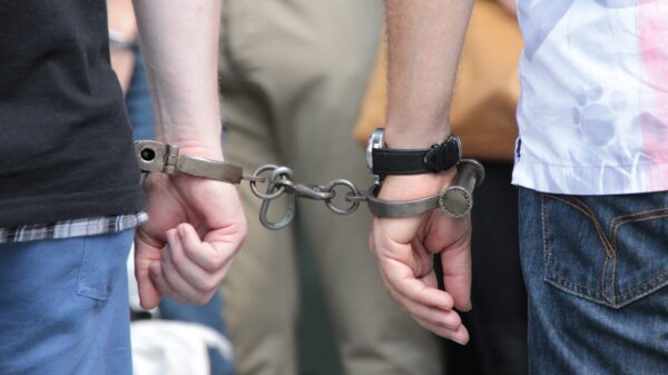 two people holding hands with handcuffs on them