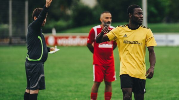 man in black long sleeve shirt holding yellow plastic cup