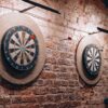 Two dartboards on a vintage brick wall create a retro vibe inside a Belarus café.