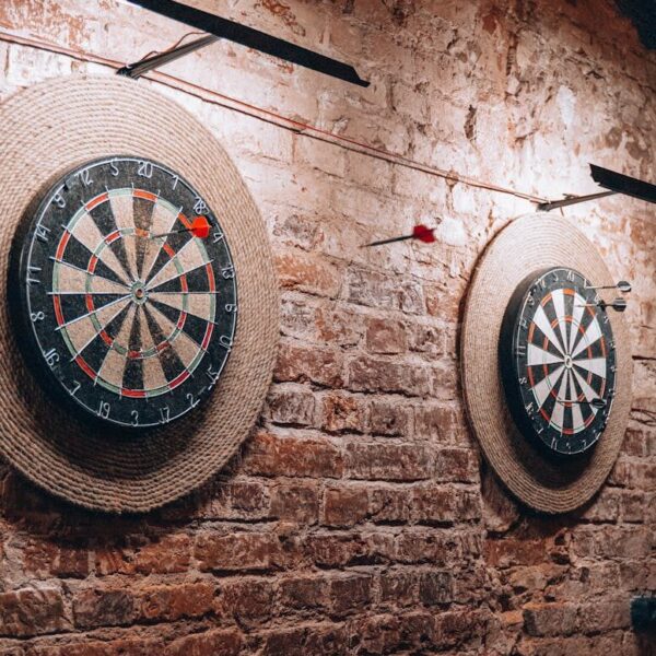 Two dartboards on a vintage brick wall create a retro vibe inside a Belarus café.