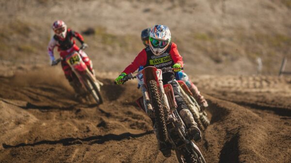 man riding motocross dirt motorcycle during daytime