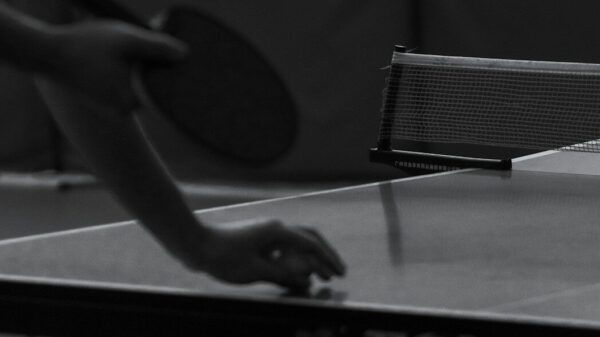 Person playing table tennis with a paddle.