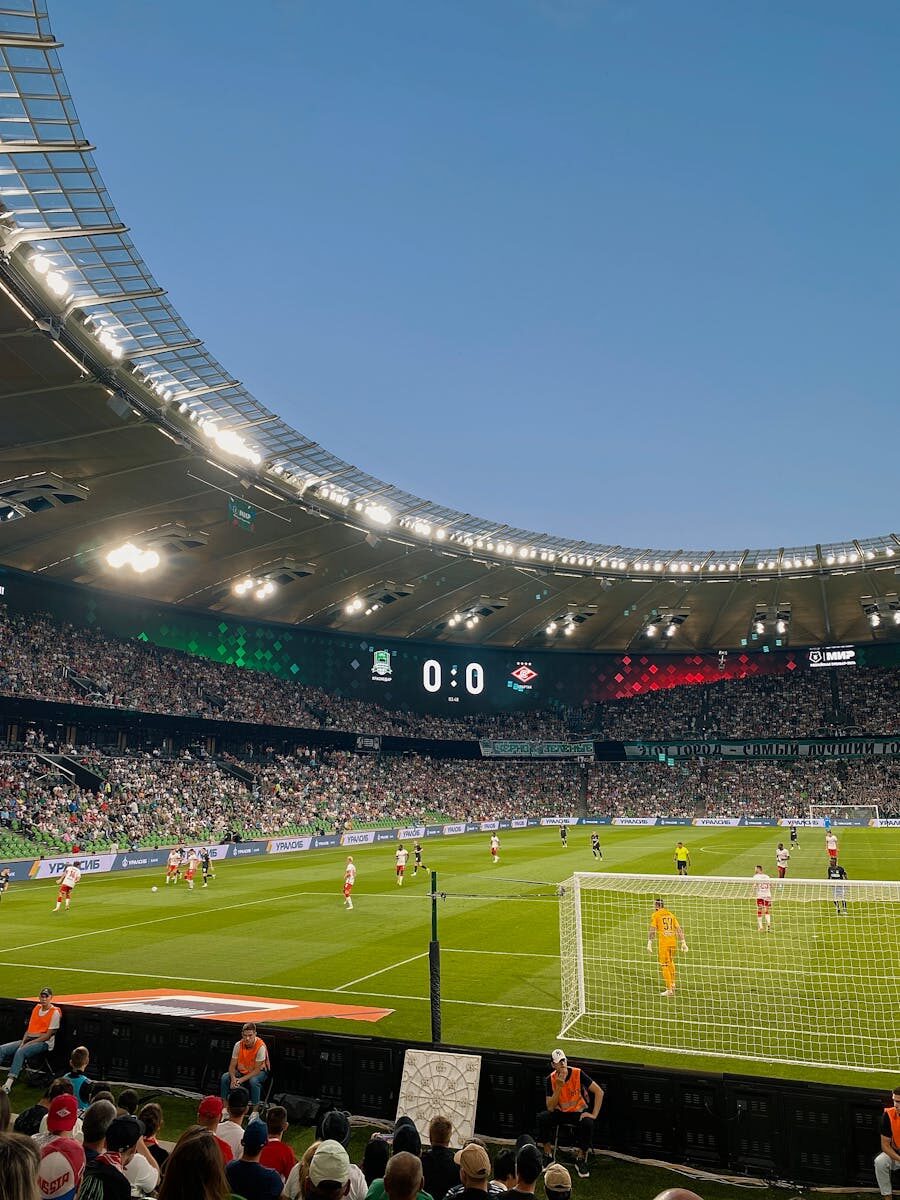A thrilling football match with packed stands at FC Krasnodar's iconic stadium.