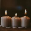 white candles on black surface
