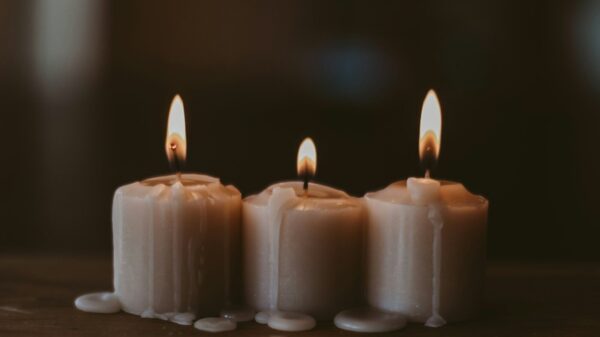 white candles on black surface