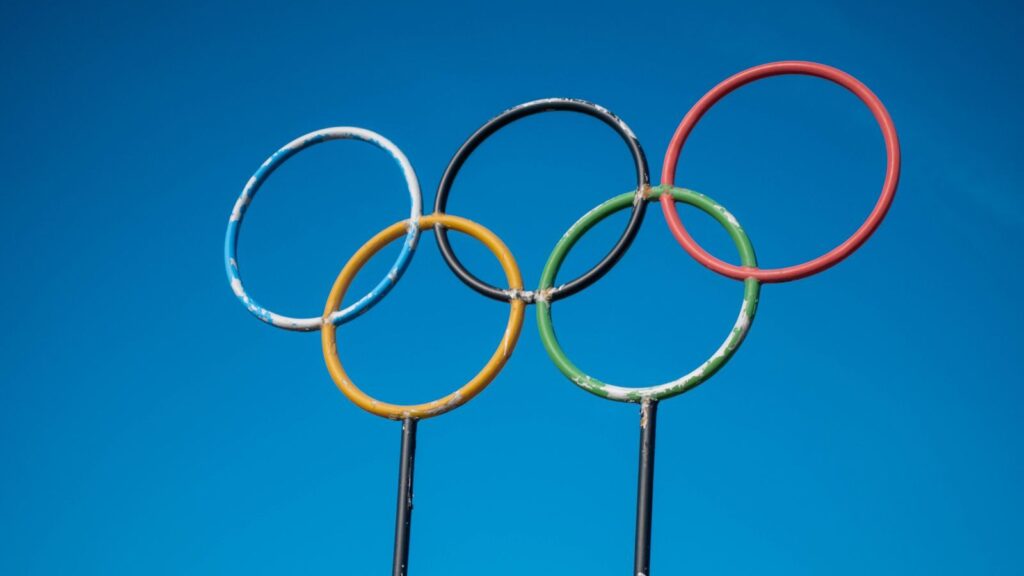 Olympic rings sculpture set against a clear blue sky in Lahti, Finland.