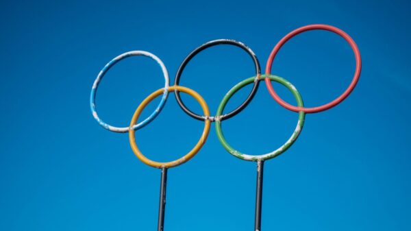 Olympic rings sculpture set against a clear blue sky in Lahti, Finland.