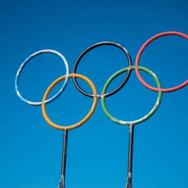 Olympic rings sculpture set against a clear blue sky in Lahti, Finland.