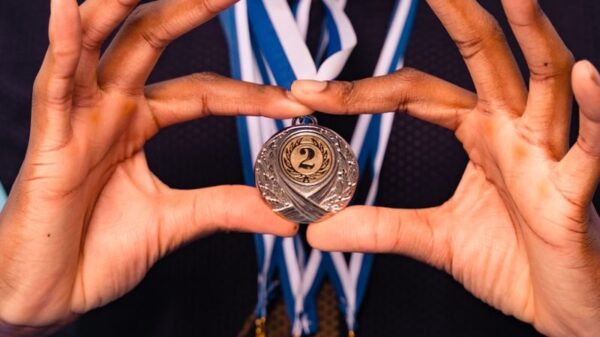 Close-up of an athlete holding medals, symbolizing victory and achievement in sports.