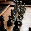 Close-up image of a chessboard with arranged pieces highlighting the game's strategy.