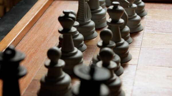 Close-up image of a chessboard with arranged pieces highlighting the game's strategy.
