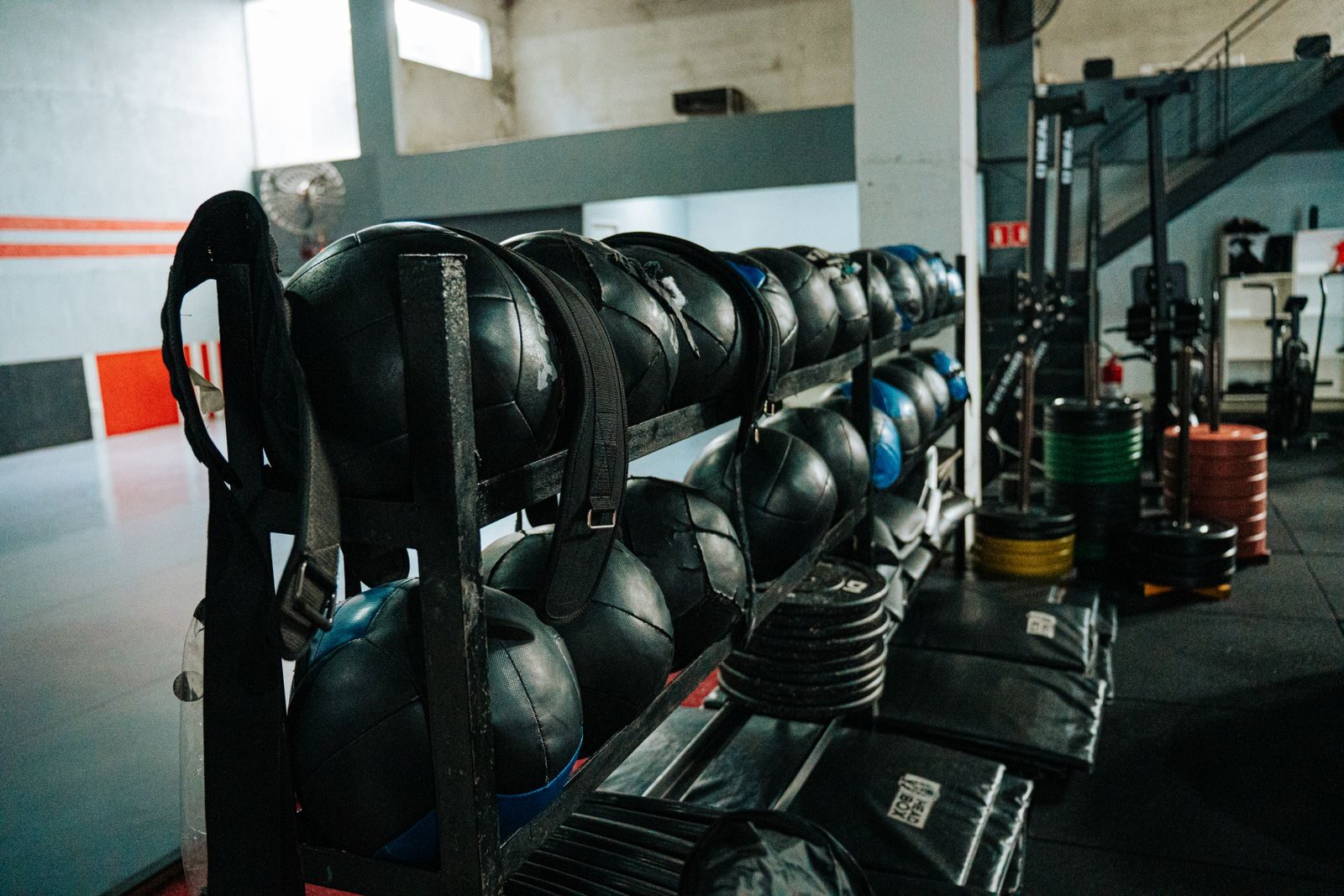 Well-equipped indoor gym featuring kettlebells, weights, and workout gear, perfect for fitness enthusiasts.