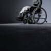 Studio shot of a person in a wheelchair with ample copy space, highlighting accessibility.