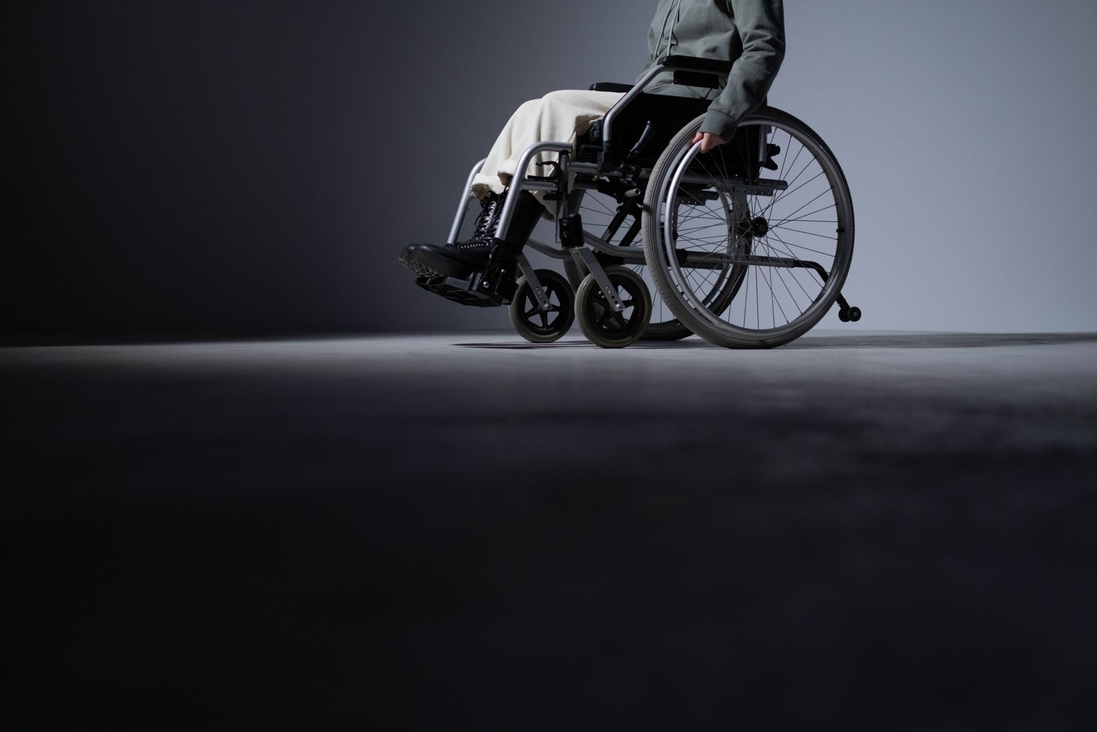 Studio shot of a person in a wheelchair with ample copy space, highlighting accessibility.